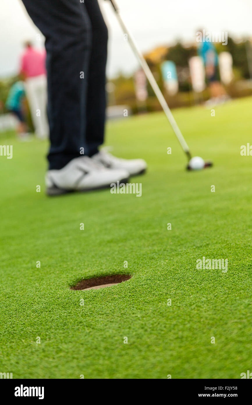 Golf player at the putting green Stock Photo