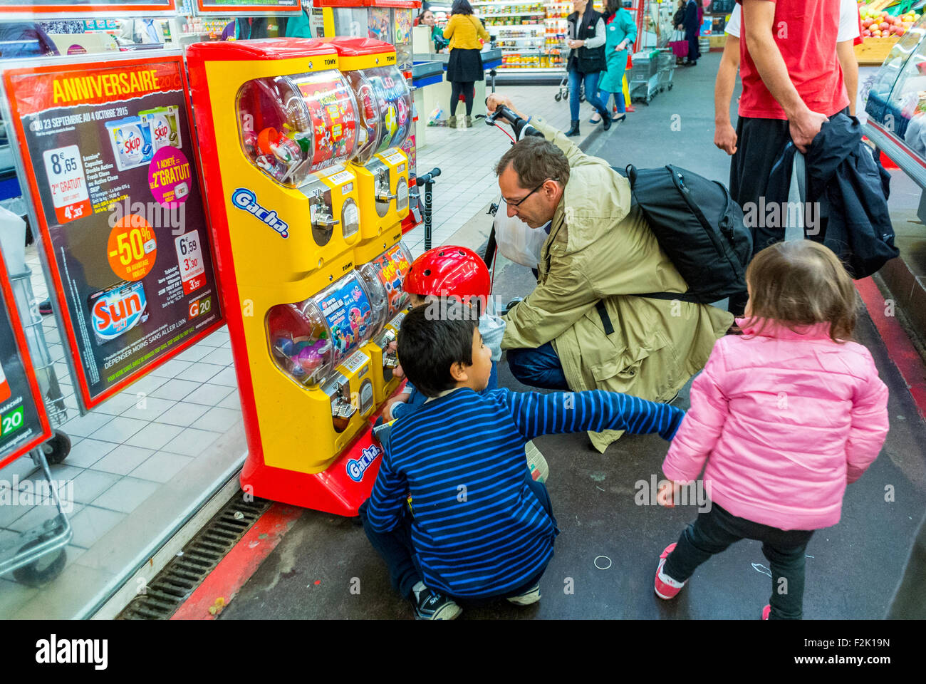 Paris, France, Family Buying Candy at vending Machine, Shopping in Public Market, Marche Batignolles, Inside Stock Photo