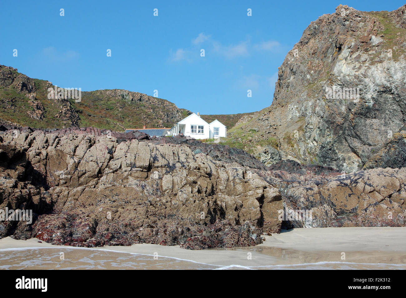 White Cornish Cottage On The Cliffs Above The Sea At Kynance Cove