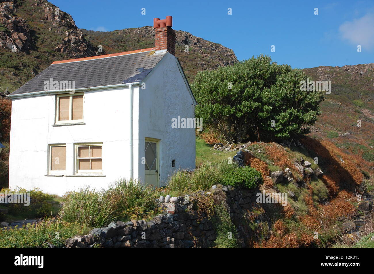 Single White Cornish Cottage Among A Mossy Hilly Landscape At