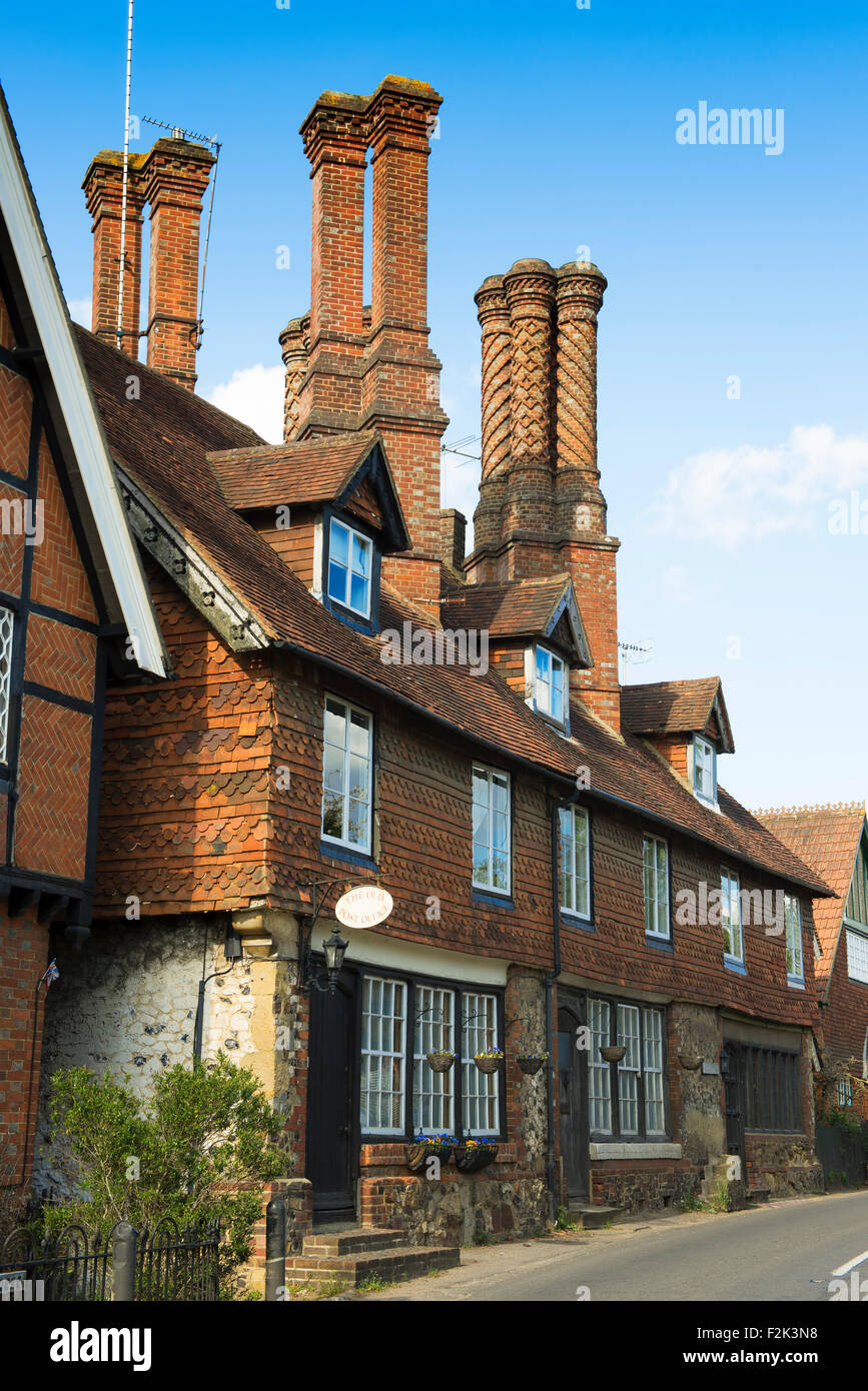 The Old Post Office with tall Elizabethan brickwork chimneys in the village of Albury, Surrey, UK Stock Photo