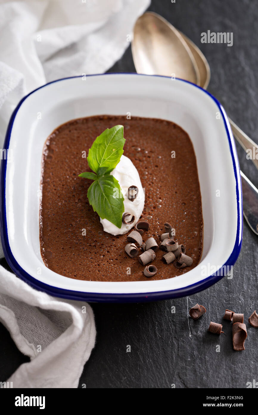 Chocolate mousse with a dollop of cream and basil made with olive oil Stock Photo