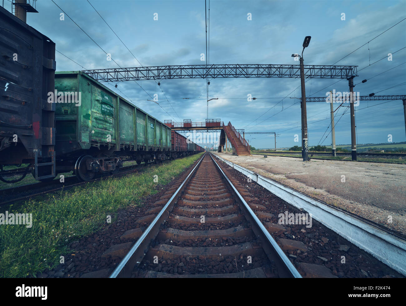 Cargo train platform at sunset. Railroad in Ukraine. Railway station. Stock Photo