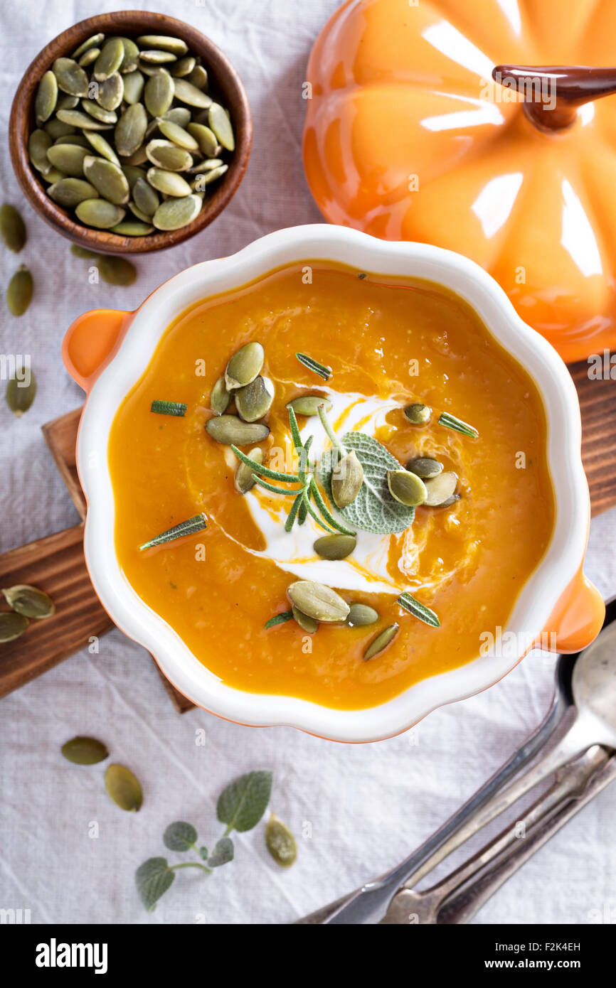 Pumpkin soup with sour cream, herbs and seeds Stock Photo