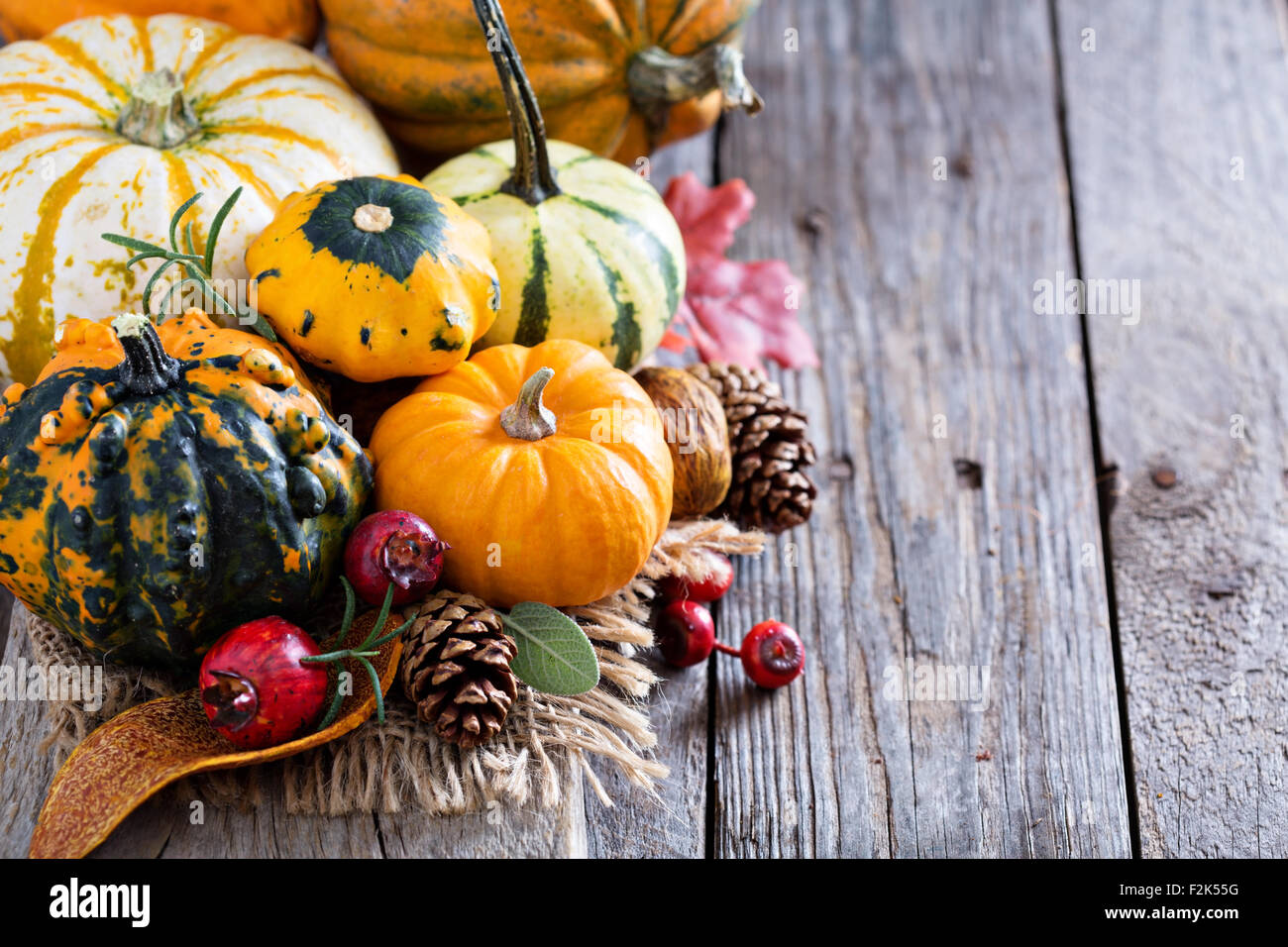 Pumpkins and variety of squash on a rustic table Stock Photo - Alamy