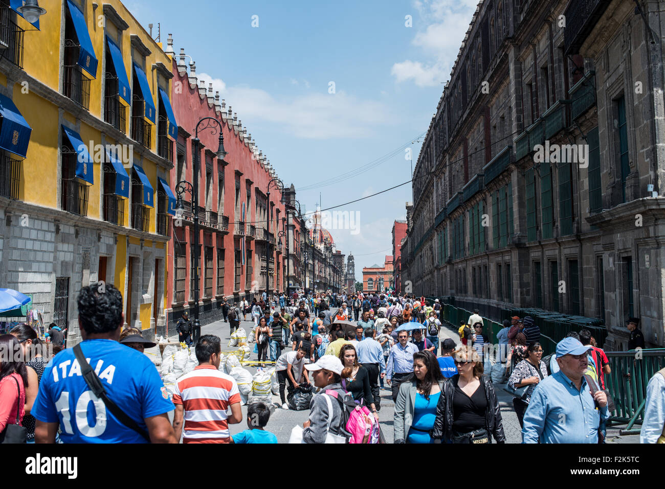 Tourists walking around Zócalo with the Metropolitan Cathedral in the background