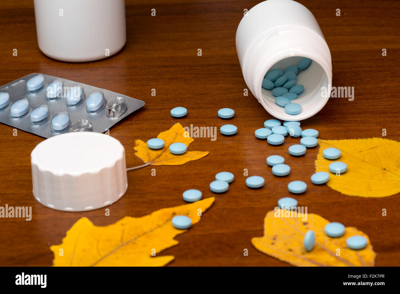 Blue pills and medicine bottle on wooden background Stock Photo