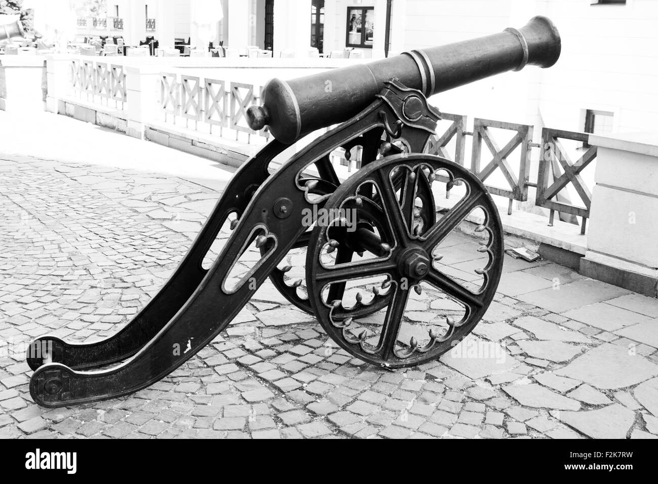 Black and white image of old cannon and cobble streets in the medieval german town of Sibiu, Romania Stock Photo
