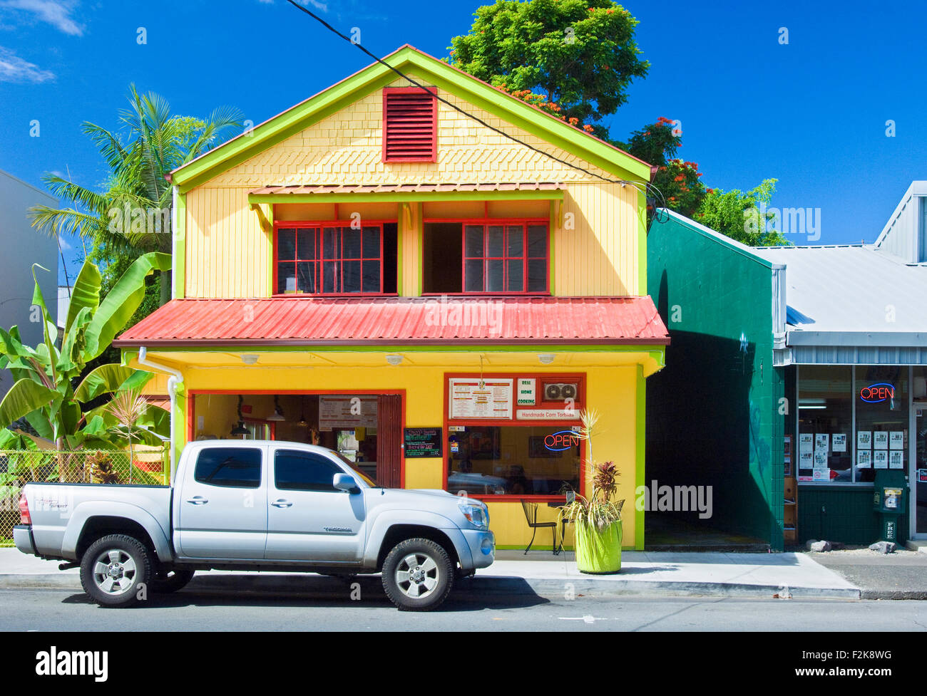 Colourful restaurant in Hilo, Hawaii on a clear sunny day with an SUV parked in front Stock Photo