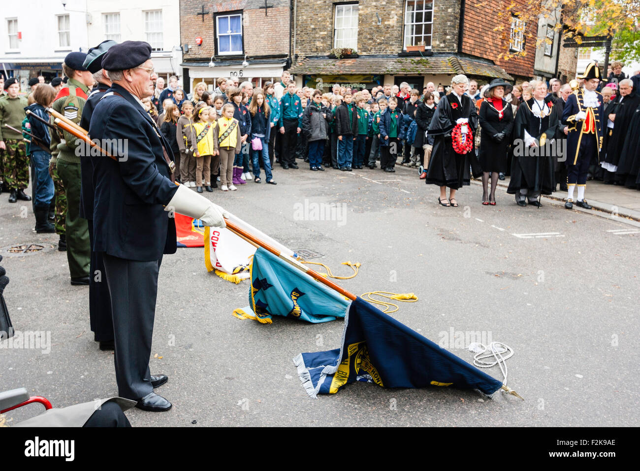 Remembrance Sunday at Sandwich town, UK. One minute silence with ex-servicemen holding lowed flags draped on street during commemoration ceremony. Stock Photo