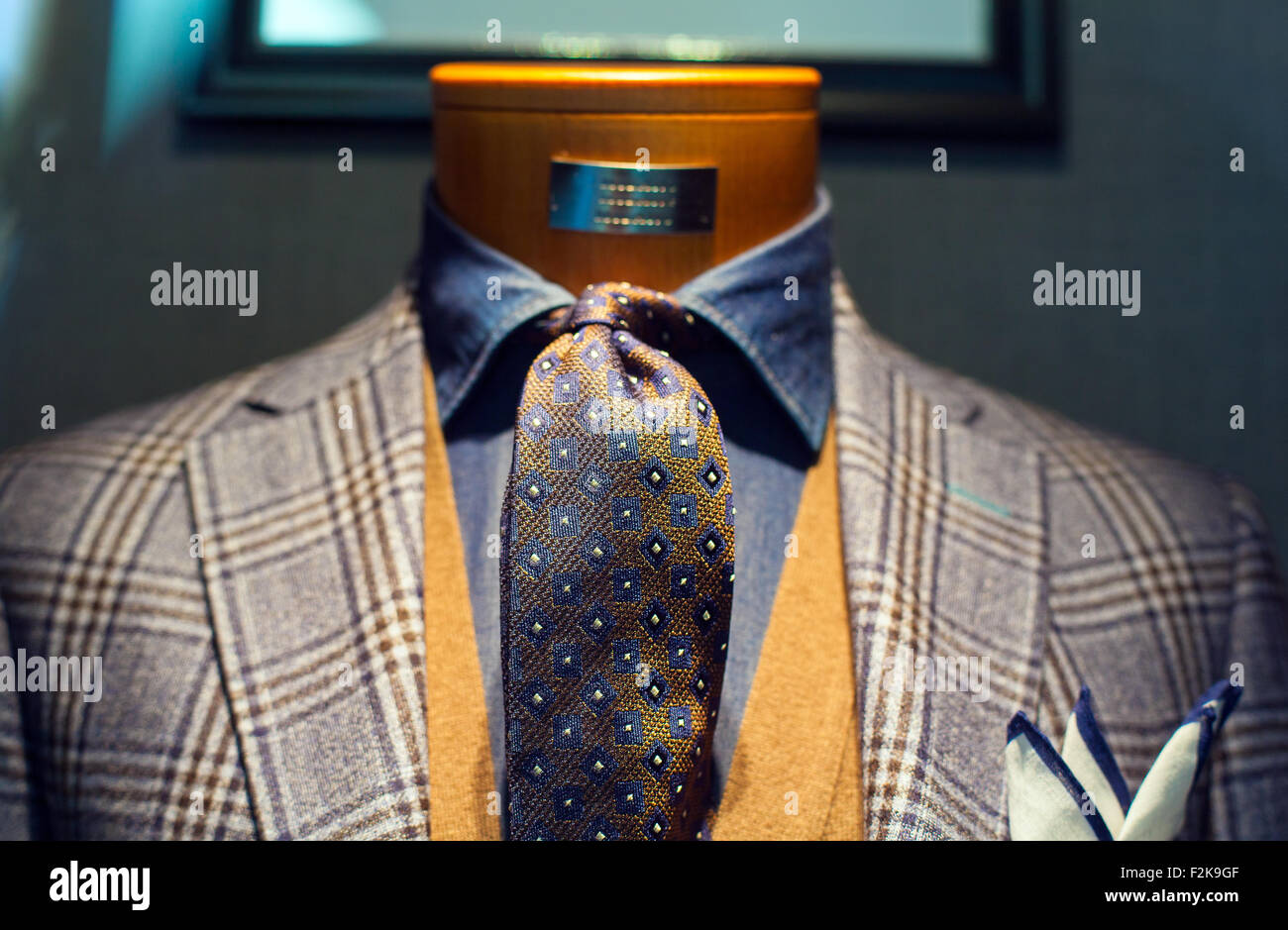 Detail of a clothing mannequin in a men suit shop with a white brick wall  on the background. Elegance concept. Square format Stock Photo - Alamy
