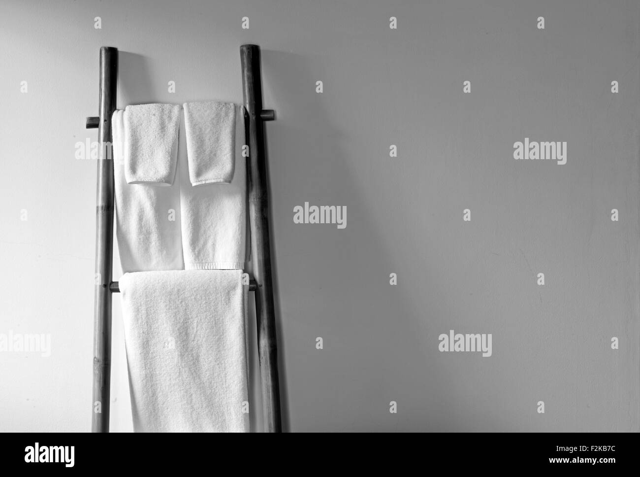 Towels hanging on the bamboo hanger and ready to use Stock Photo