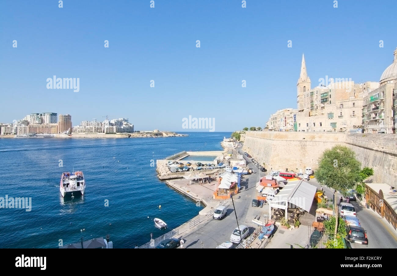 Sliema skyline and ferry en route from Sliema to Valletta ferry terminal Stock Photo