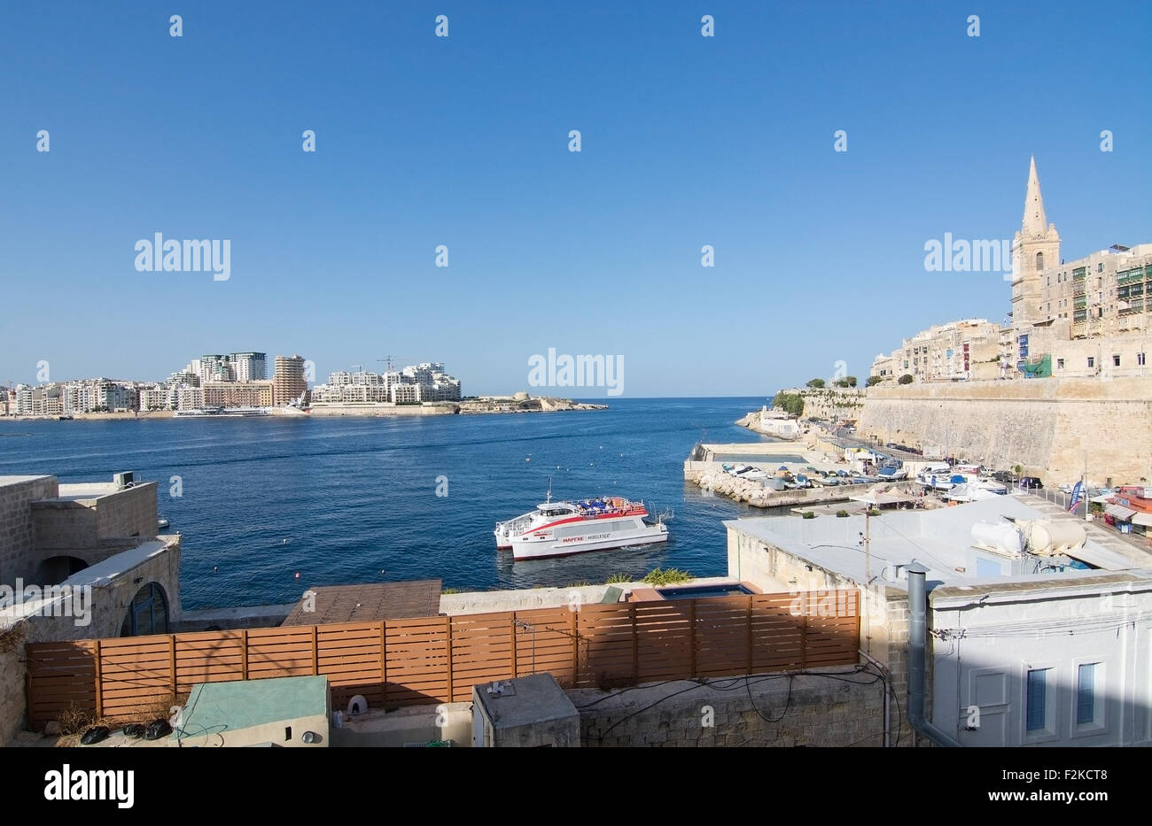 Sliema skyline and ferry en route from Sliema to Valletta ferry terminal Stock Photo