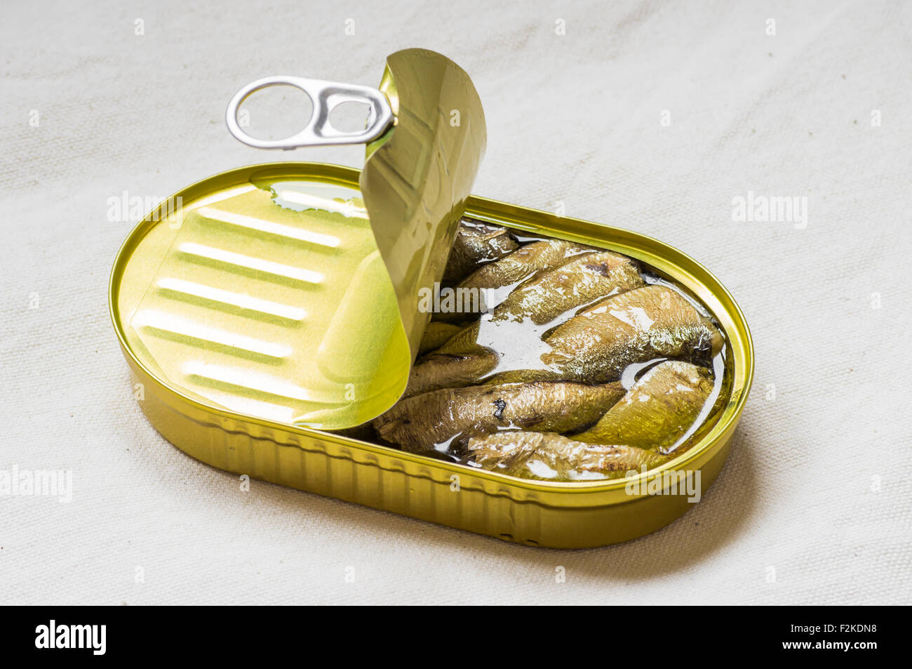 Cans fish oil on a white tablecloth Stock Photo