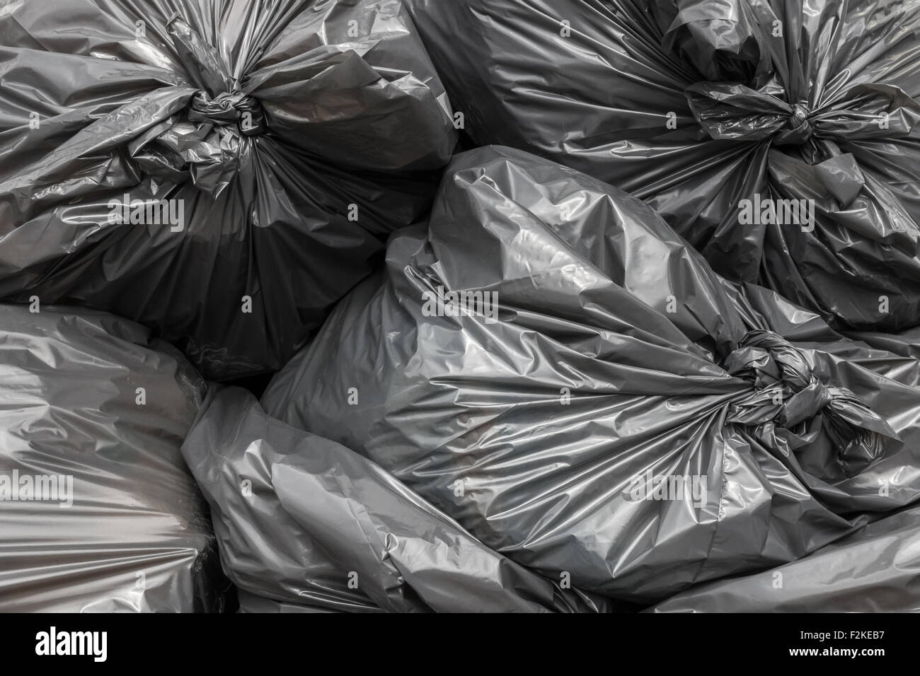 Garbage bags blacks stacked and ready to be picked Stock Photo - Alamy