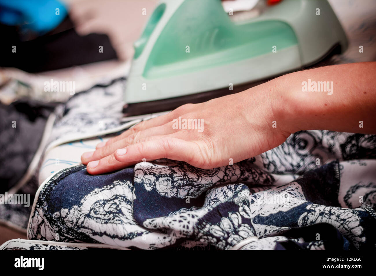 Young woman ironing her clothes Stock Photo Alamy
