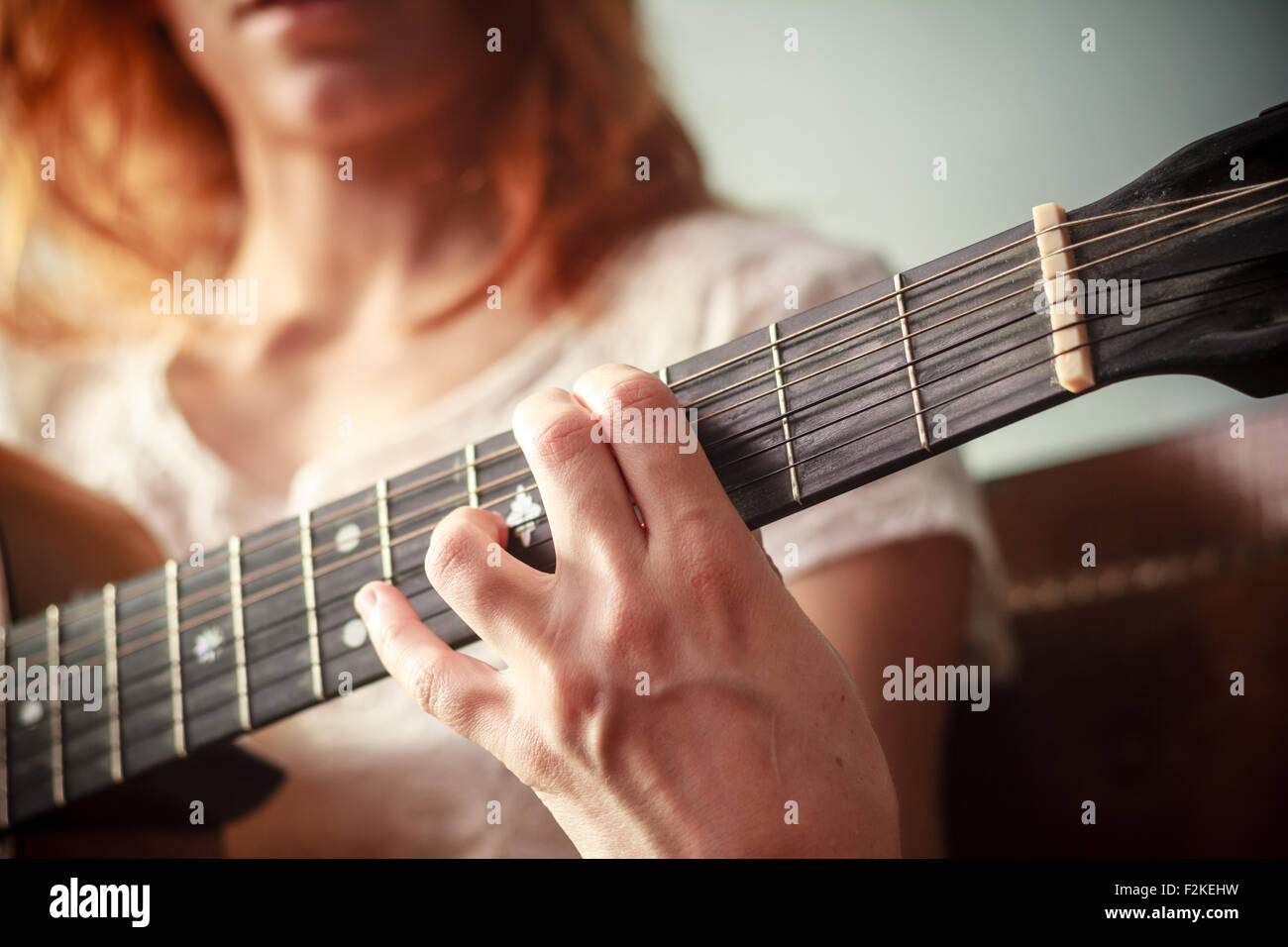 Young woman playing guitar Stock Photo - Alamy