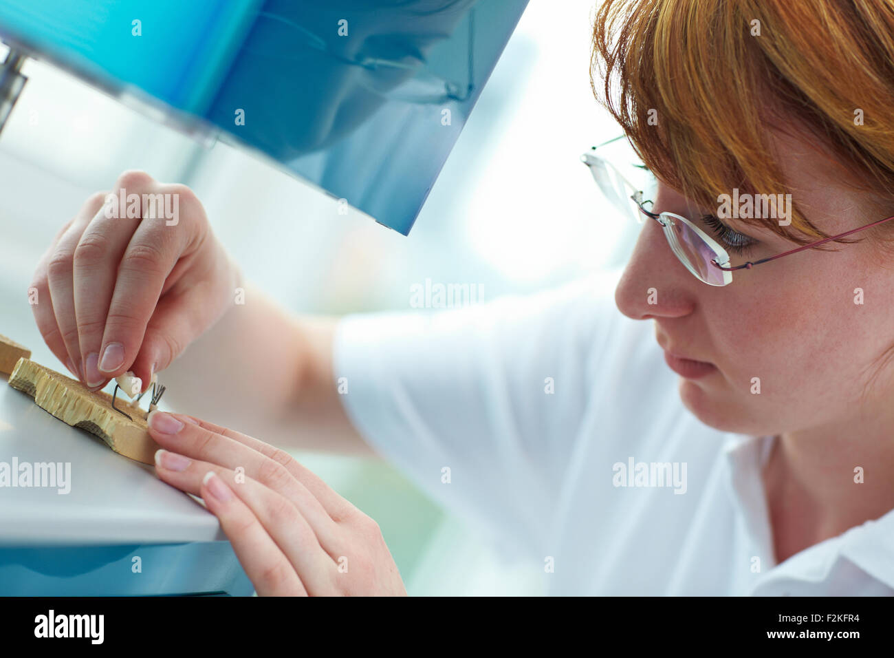 Dental technician working on ceramic coronas in a lab Stock Photo Alamy