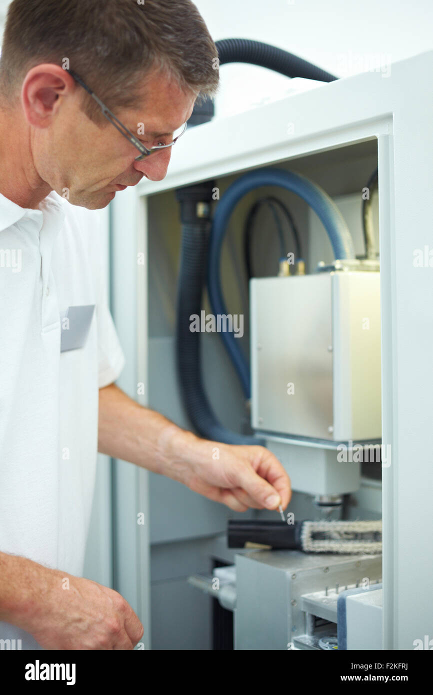 Dental technician working with a CAD CAM Stock Photo