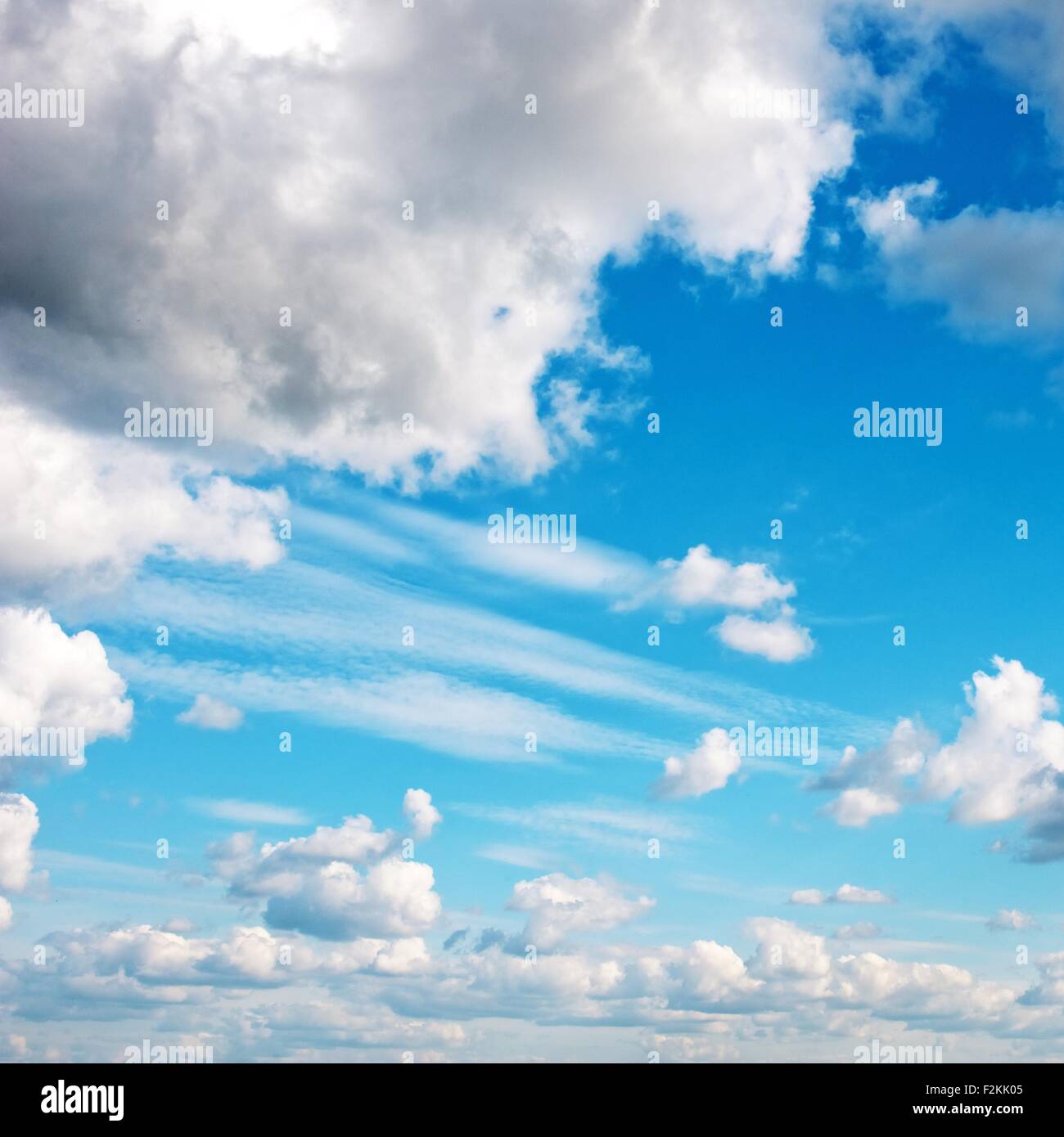 Blue sky with fluffy clouds Stock Photo - Alamy