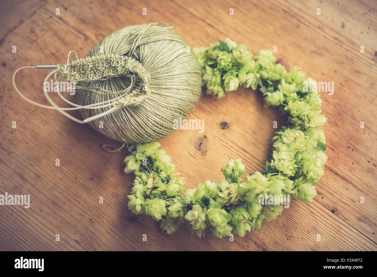 Self-made hop wreath and ball of wool Stock Photo