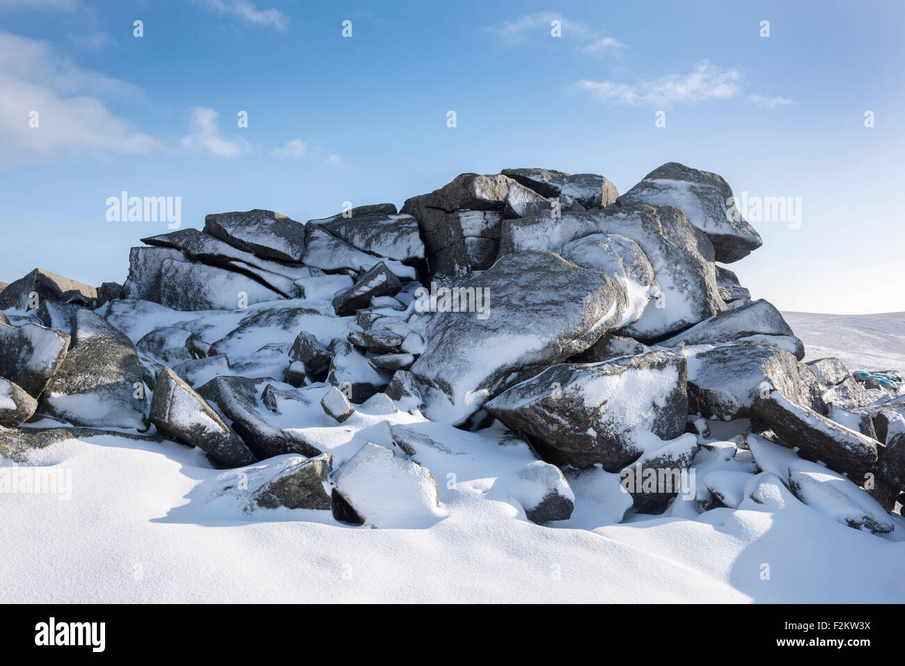 Frozen granite rocks in snow at Belstone Tor on Dartmoor, England. Stock Photo