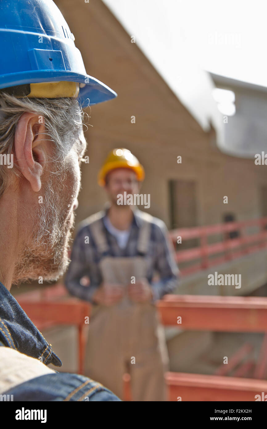 Two men with hard hats on construction site Stock Photo Alamy