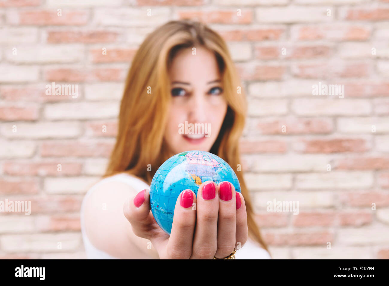 Hand in hand holding a globe hi-res stock photography and images - Alamy