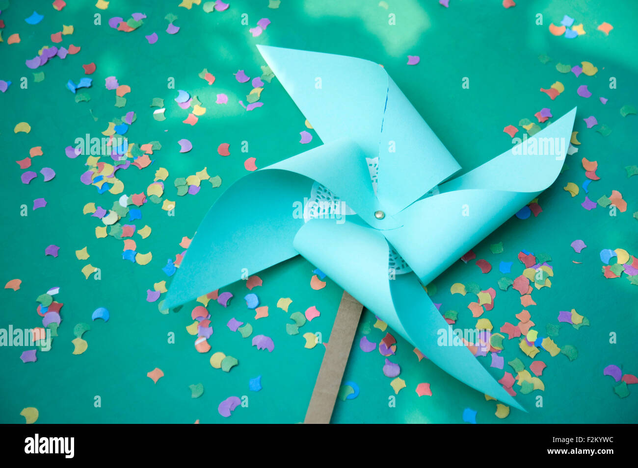 Self-made party decoration, paper windmill and confetti Stock Photo