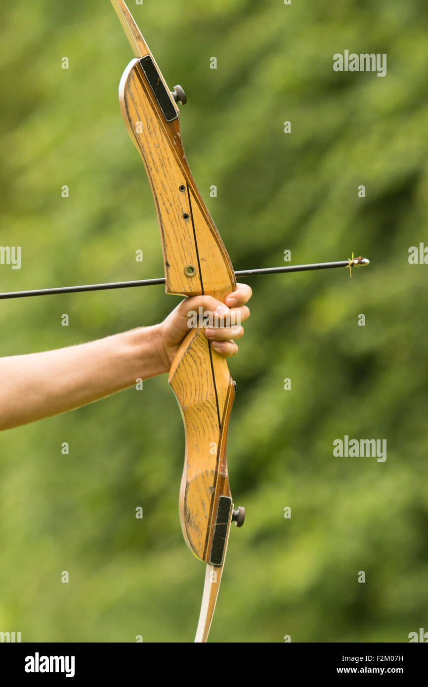 Arm holding Bow and Arrow ready to be loosed Stock Photo