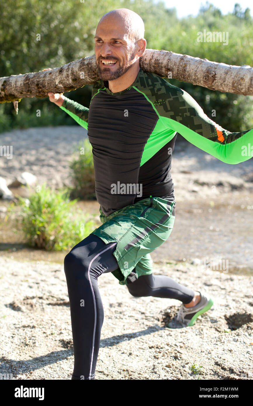 Man carrying log on shoulders hi-res stock photography and images - Alamy