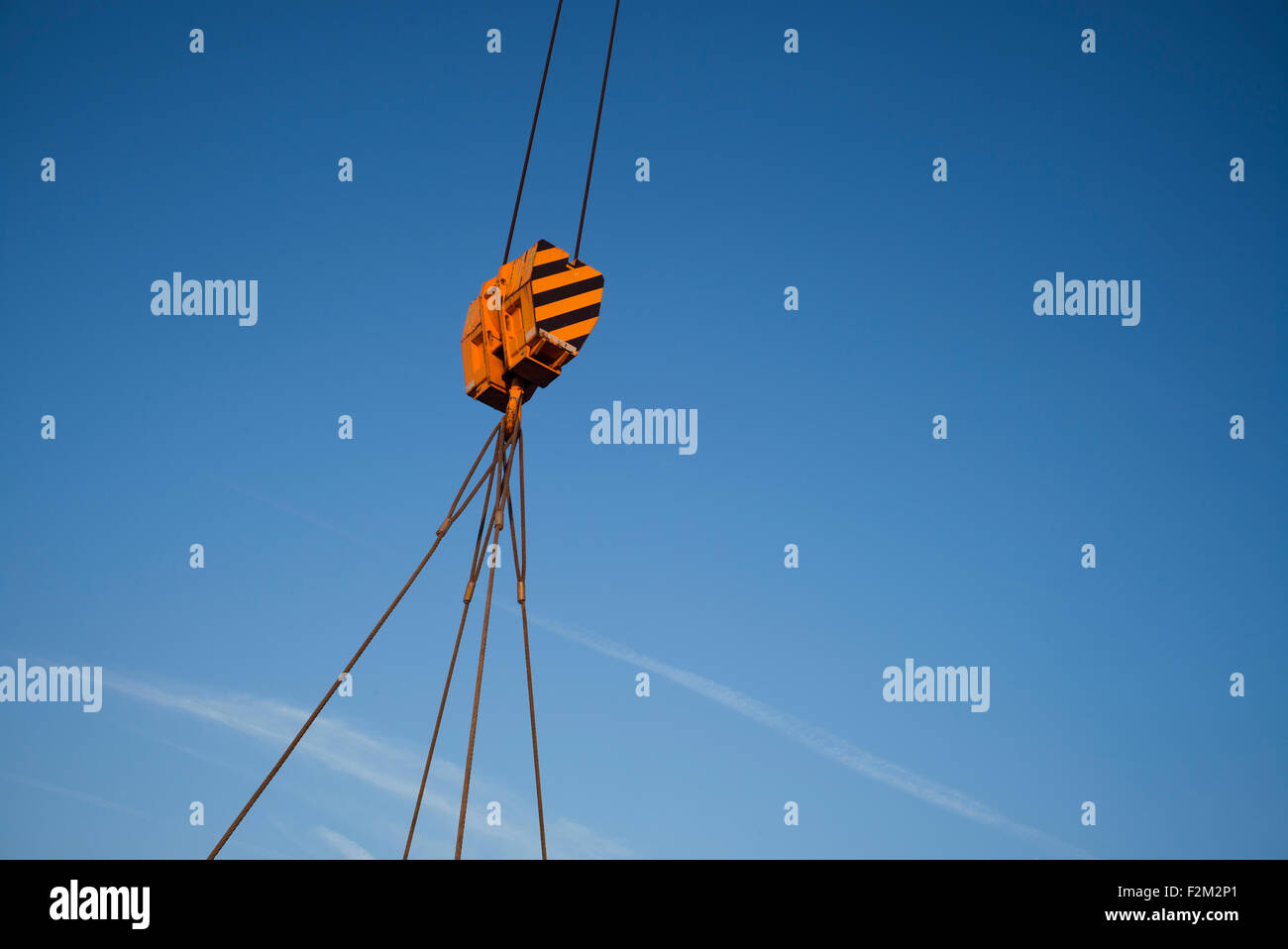 Pulley on crane,cables against blue sky Stock Photo