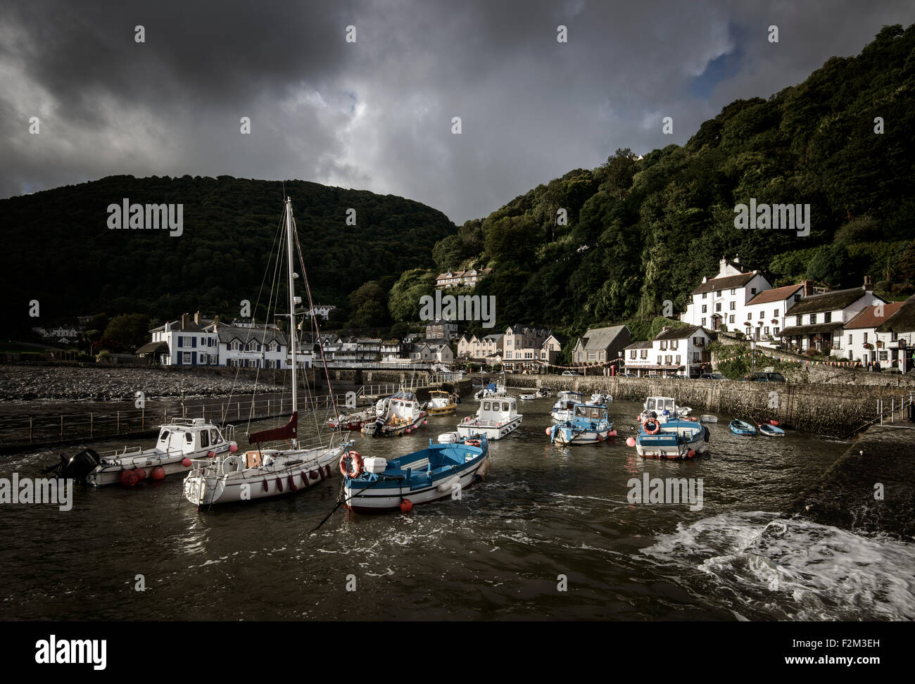 Lynmouth harbor, under moody skies, at high tide. Stock Photo