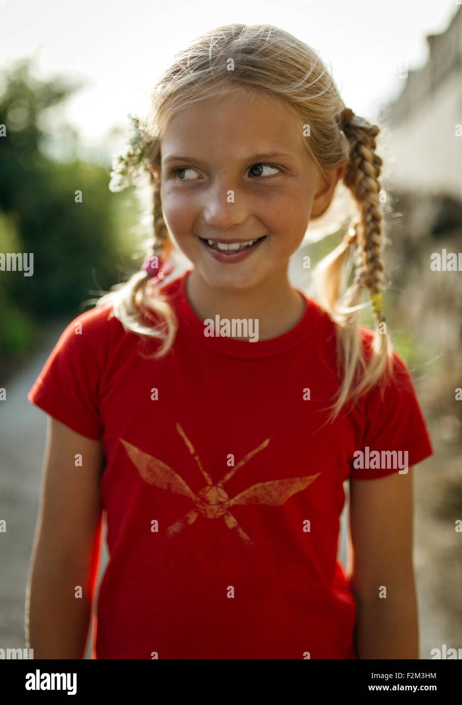Portrait of smiling little girl with braids Stock Photo - Alamy