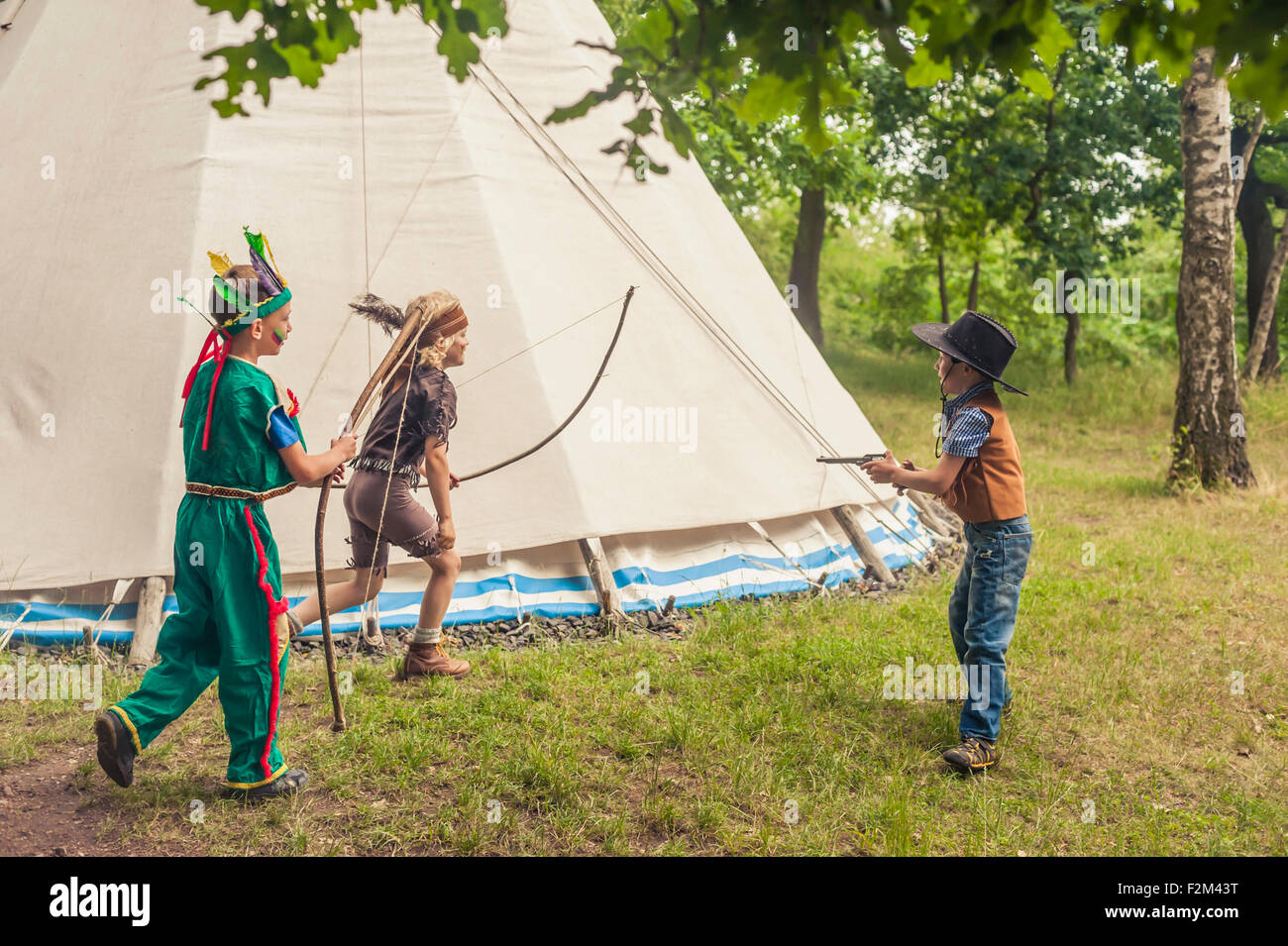 Germany, Saxony, Indians and cowboy party, Boys playing with bow and arrow Stock Photo