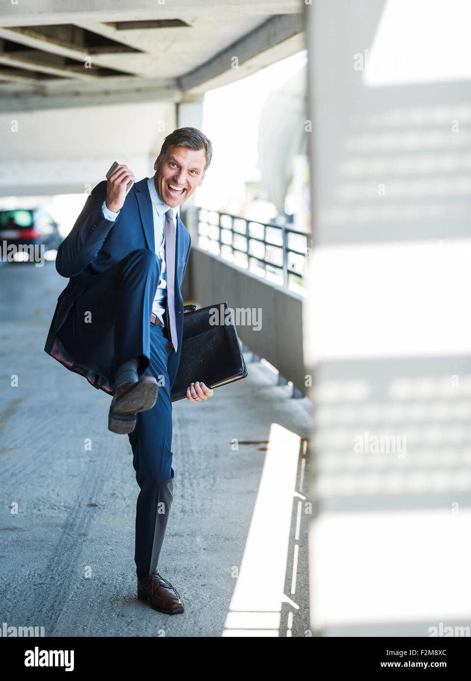 Successful businessman cheering on park deck Stock Photo