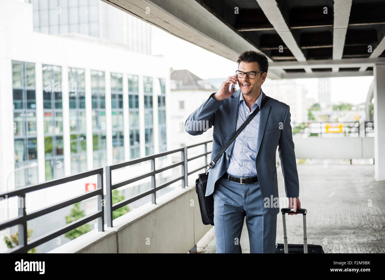 Businessman on business trip telephoning with smartphone Stock Photo