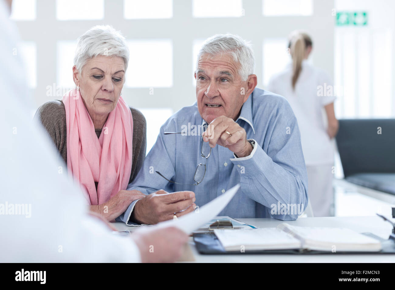 Doctor advising couple hi-res stock photography and images - Alamy