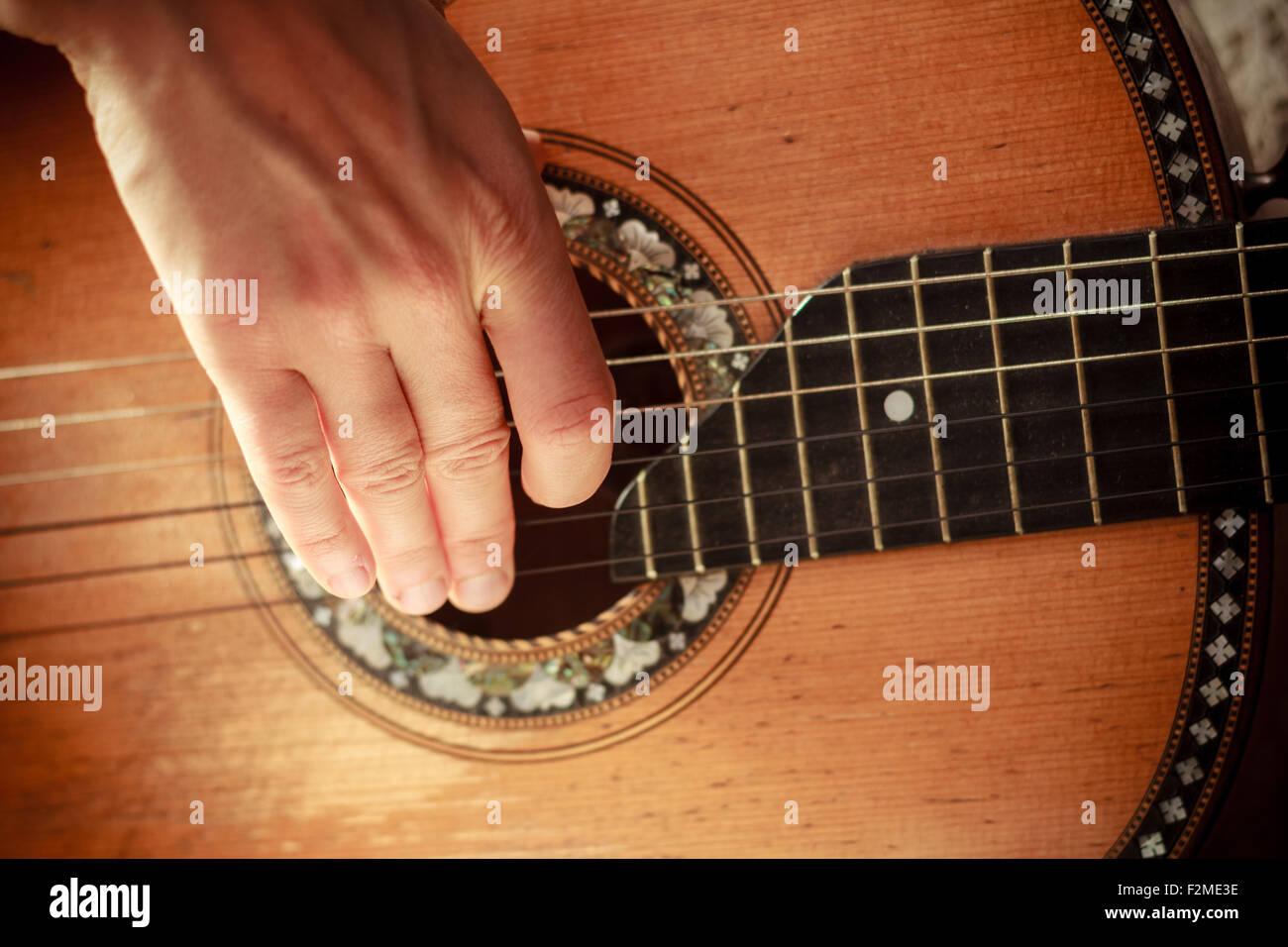 Close up on the hand of a young woman playing guitar Stock Photo