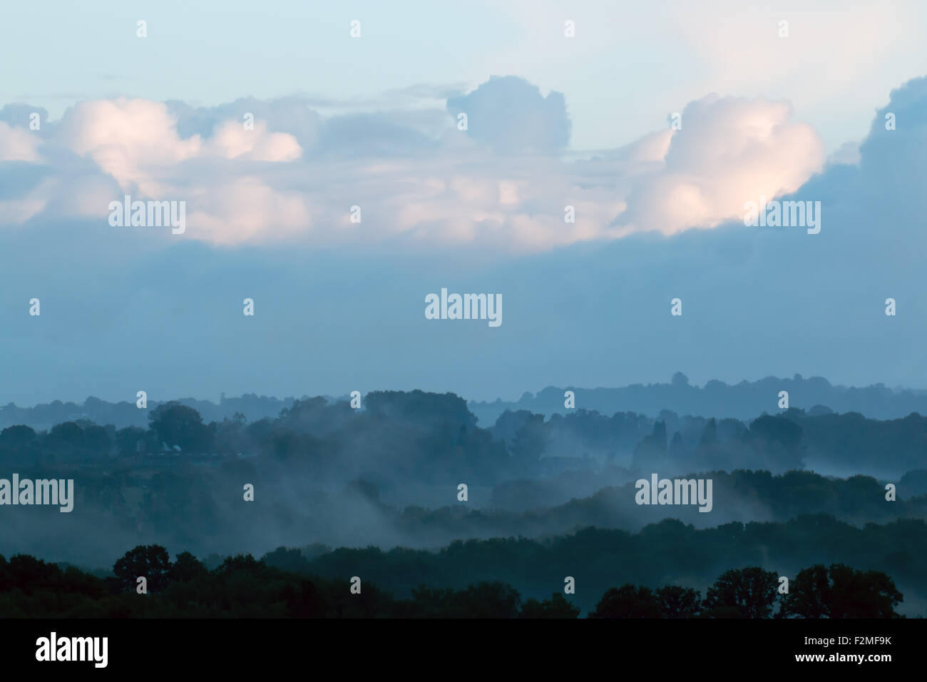 Mist across valley with clouds. Stock Photo