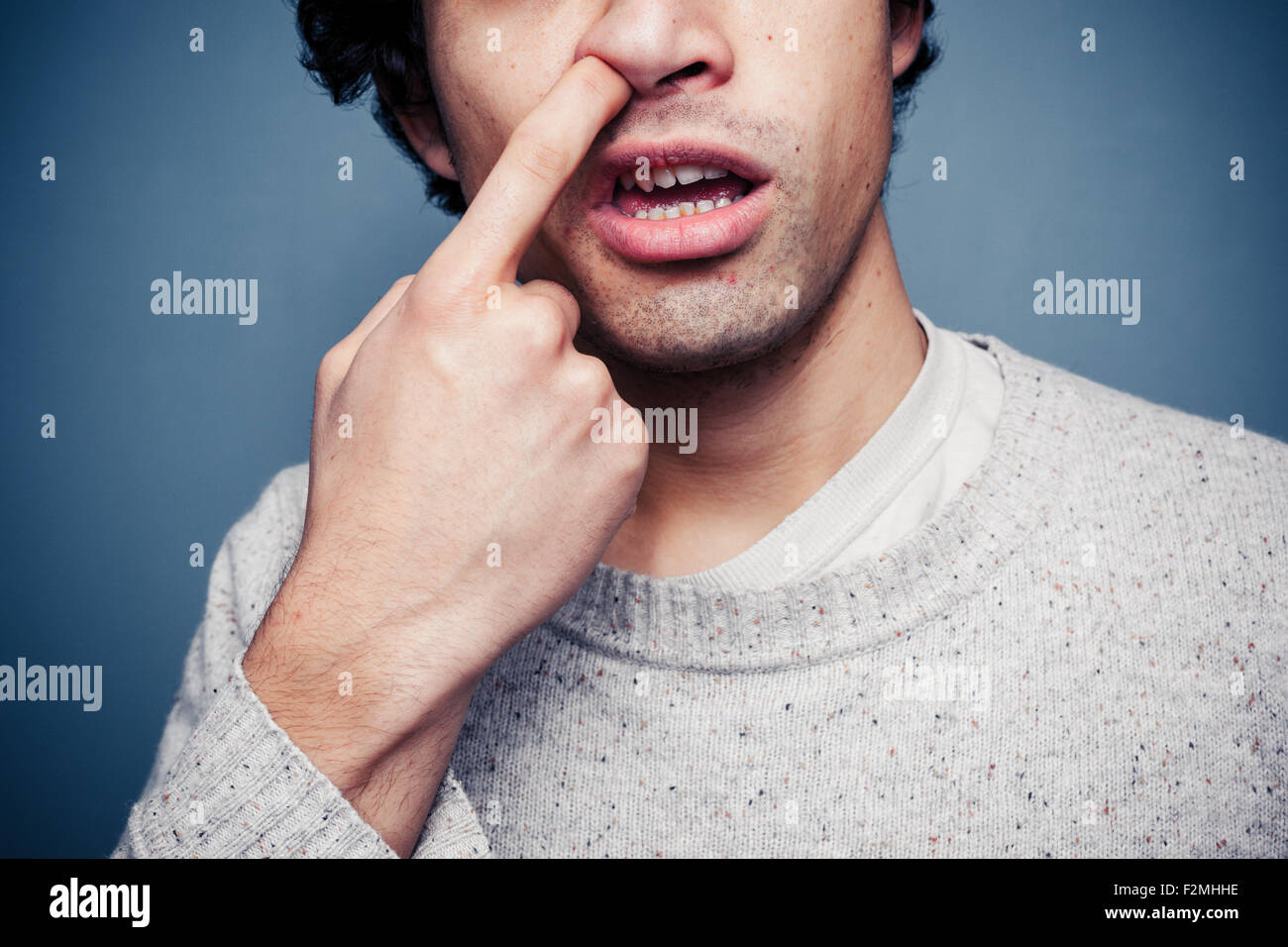 Young man picking his nose Stock Photo