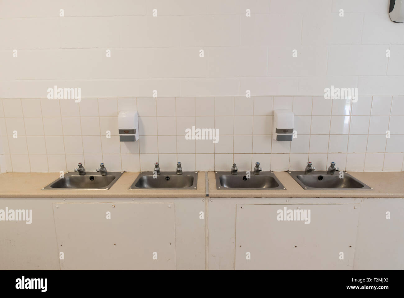Hand wash basins and soap dispensers public toilets at Milton Country Park Stock Photo