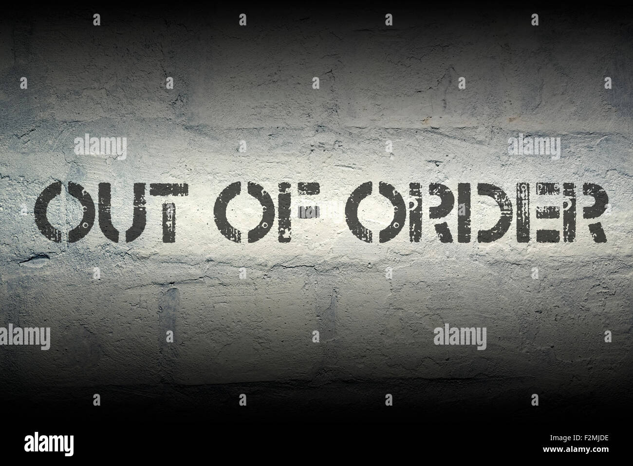 out of order stencil print on the grunge white brick wall Stock Photo