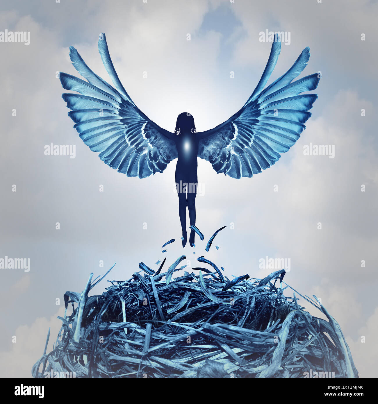 Angel concept and angelic metaphor as a human with open wings rising out of a nest into the clouds as a symbol of hope and the aspirations of life and to ascend to personal learning achievement. Stock Photo
