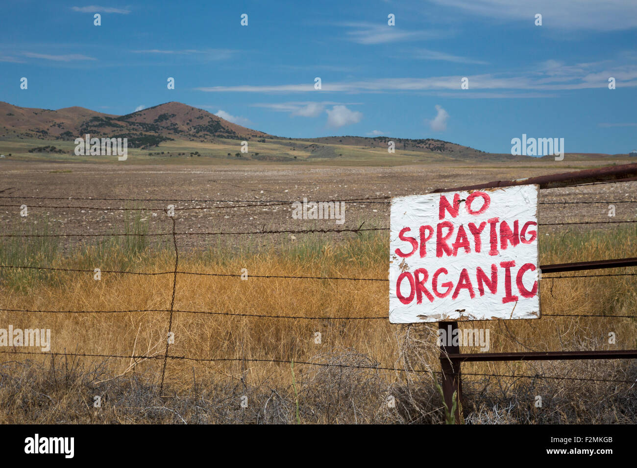 Promontory, Utah - A sign at a farmer's field warns against spraying because the farm is organic. Stock Photo