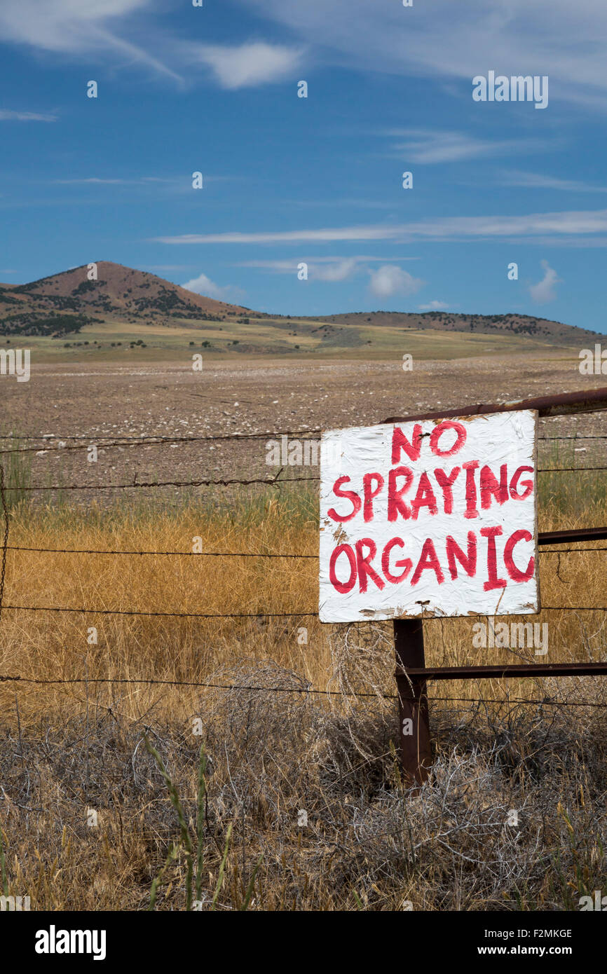 Promontory, Utah - A sign at a farmer's field warns against spraying because the farm is organic. Stock Photo