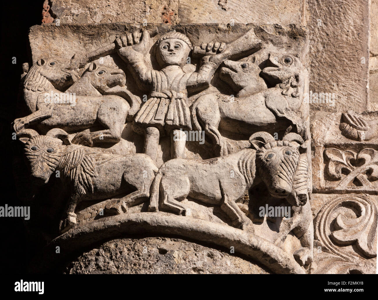 Romanesque carved stone capital at Basilica di Sant' Ambrogio in Milan with sheep, shepherd, staff, and sheep dogs Stock Photo
