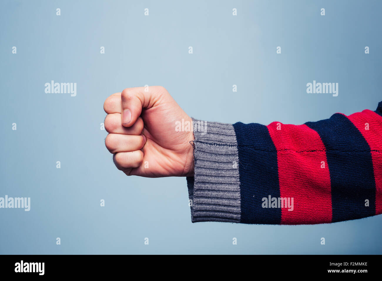 Young man clenching his fist Stock Photo