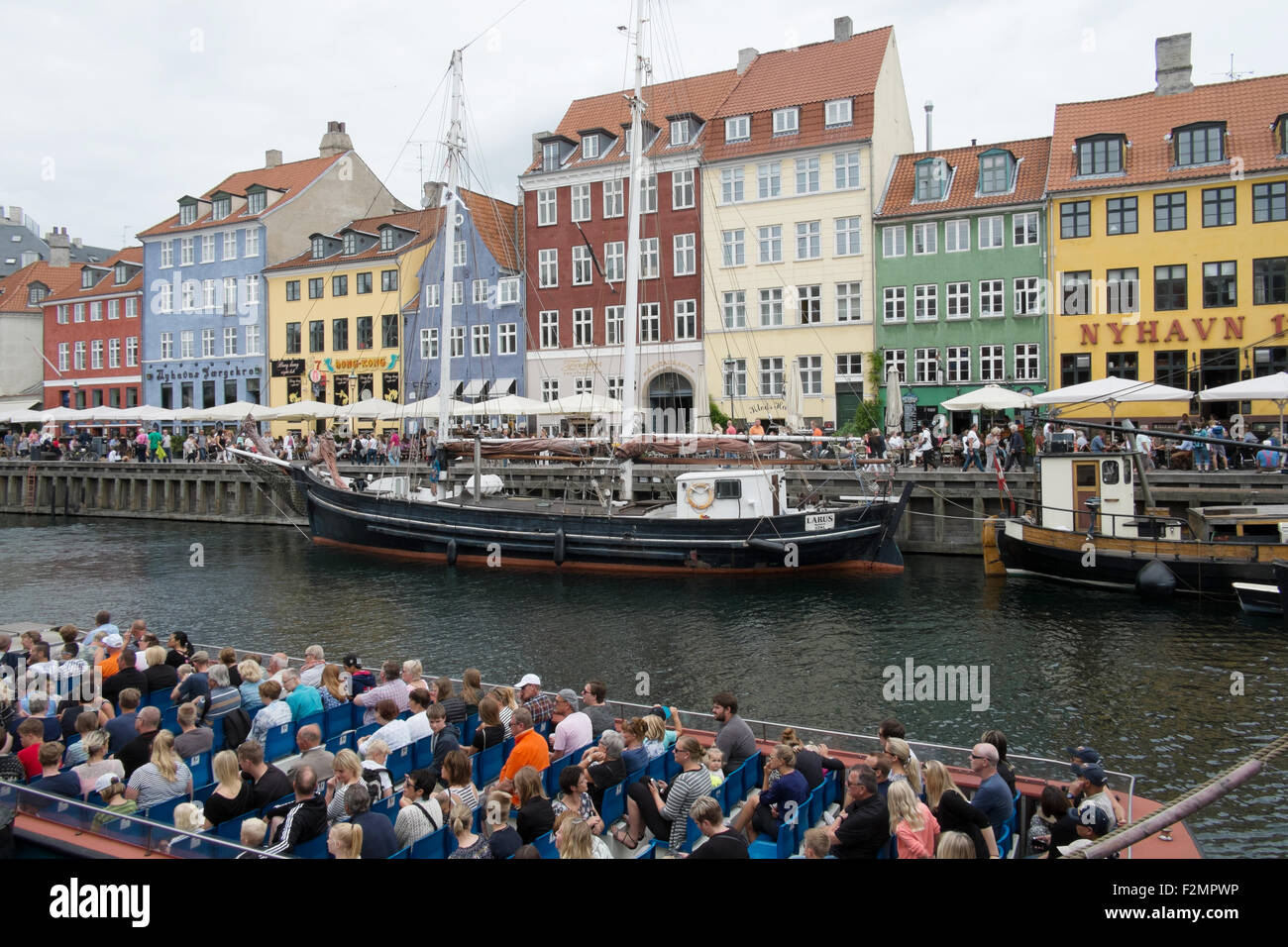 Tourists taking a canal trip at Nyhavn New Harbour Copenhagen Denmark Stock Photo